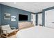 Serene bedroom with TV, walk-in closet, light colored walls and a comfortable bed with a ceiling fan at 3702 5Th Ave, Holmes Beach, FL 34217