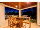 Outdoor kitchen with bar seating and BBQ grill, perfect for entertaining guests at 3702 5Th Ave, Holmes Beach, FL 34217