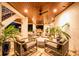 Charming outdoor seating area with overhead wood ceiling, ceiling fans and comfortable seating at 3702 5Th Ave, Holmes Beach, FL 34217