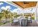 This patio features a beautiful view, comfortable seating, and a stained wood ceiling at 3702 5Th Ave, Holmes Beach, FL 34217