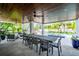 Expansive outdoor patio with a large dining table, comfortable seating, and serene views of the pool area at 3702 5Th Ave, Holmes Beach, FL 34217