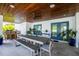 Covered patio featuring an outdoor kitchen, spacious dining area, and comfortable seating for entertaining at 3702 5Th Ave, Holmes Beach, FL 34217