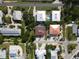 Bird's eye view of the house with a beautiful brown roof, luscious greenery, and an outdoor pool at 3703 5Th Ave # 3, Holmes Beach, FL 34217