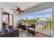 Relaxing screened balcony with comfortable seating area and a view of tropical scenery and beautiful blue skies at 3703 5Th Ave # 3, Holmes Beach, FL 34217