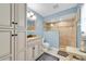 Bathroom featuring a tiled shower, granite vanity, and coastal-inspired design at 3703 5Th Ave # 3, Holmes Beach, FL 34217