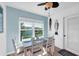 Charming dining area with window views and a decorative ceiling fan, adjacent to a sliding glass door at 3703 5Th Ave # 3, Holmes Beach, FL 34217