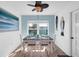 Coastal dining room with seating for four, blue accent wall, and decorative fish art at 3703 5Th Ave # 3, Holmes Beach, FL 34217