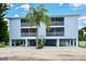 Coastal home featuring two stories, stilt construction, a well-manicured lawn and multiple screened-in balconies at 3703 5Th Ave # 3, Holmes Beach, FL 34217