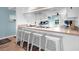 Breakfast bar with white stools, offering a casual dining spot in the well-lit kitchen with a view at 3703 5Th Ave # 3, Holmes Beach, FL 34217