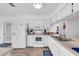 Bright, all-white kitchen featuring modern appliances, ample counter space, and sleek cabinetry for easy meal prep at 3703 5Th Ave # 3, Holmes Beach, FL 34217