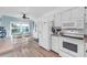Well-equipped kitchen with bright lighting, essential appliances, and a cozy dining area for enjoyable meals at 3703 5Th Ave # 3, Holmes Beach, FL 34217