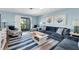 Comfortable living room featuring plush seating, stylish decor, and sliding glass doors to a private balcony at 3703 5Th Ave # 3, Holmes Beach, FL 34217