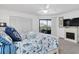 Well-lit main bedroom featuring access to the outside patio and a decorative fireplace at 3703 5Th Ave # 3, Holmes Beach, FL 34217