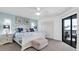Bright main bedroom with blue and white bedding, a view of the outdoor patio, and closet at 3703 5Th Ave # 3, Holmes Beach, FL 34217