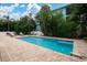 Enjoy this serene pool with brick paved deck surrounded by tropical foliage and trees at 3703 5Th Ave # 3, Holmes Beach, FL 34217
