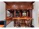 Custom-built bar area with dark wood, decorative columns, and comfortable seating at 3800 Gulf Blvd # Ph, St Petersburg, FL 33706