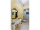 Elegant bathroom features a large, ornate mirror, a pedestal sink, and a glass enclosed shower with neutral tile at 3800 Gulf Blvd # Ph, St Petersburg, FL 33706