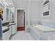 Bathroom with double sinks, large tub, and tiled floors at 3800 Gulf Blvd # Ph, St Petersburg, FL 33706