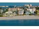 Breathtaking beach view showcasing beachfront homes and condos, pristine sandy beach, and clear blue waters at 3800 Gulf Blvd # Ph, St Petersburg, FL 33706