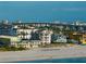 Expansive beach view with beachfront homes, a bridge, and clear blue waters, highlighting the coastal charm of the area at 3800 Gulf Blvd # Ph, St Petersburg, FL 33706