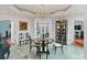 Elegant dining room with chandelier, beautiful display case, and views of the ocean at 3800 Gulf Blvd # Ph, St Petersburg, FL 33706
