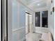 Interior hallway featuring an elevator, custom millwork, and tiled flooring at 3800 Gulf Blvd # Ph, St Petersburg, FL 33706