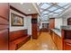 Spacious kitchen featuring hardwood floors, bench seating, and stainless steel appliances at 3800 Gulf Blvd # Ph, St Petersburg, FL 33706