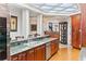 Elegant kitchen with granite countertops, wood cabinets, and an adjacent dining area at 3800 Gulf Blvd # Ph, St Petersburg, FL 33706