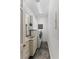 Functional laundry room equipped with a stacked washer/dryer, a built-in sink, and storage cabinets for convenience at 3800 Gulf Blvd # Ph, St Petersburg, FL 33706