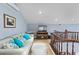Bright living room offering a cozy seating area and a view of the staircase, creating an inviting and stylish atmosphere at 3800 Gulf Blvd # Ph, St Petersburg, FL 33706