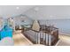 This spacious loft area features wood floors, a chandelier, a sitting area and white trim throughout at 3800 Gulf Blvd # Ph, St Petersburg, FL 33706