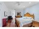 Spacious bedroom with hardwood floors, large bed, and a view of the outside at 3800 Gulf Blvd # Ph, St Petersburg, FL 33706