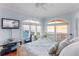 Tranquil bedroom with ocean views through arched windows and light blue walls at 3800 Gulf Blvd # Ph, St Petersburg, FL 33706