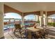 A covered patio with a table and chairs is located near the pool offering views of the beach at 3800 Gulf Blvd # Ph, St Petersburg, FL 33706