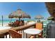 Inviting beachfront restaurant with tiki umbrellas, outdoor seating, and views of the ocean at 409 Bryn Mawr Is, Bradenton, FL 34207