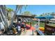 Waterfront dock featuring boat access, a covered seating area, and beautiful landscaping for enjoying waterfront views at 409 Bryn Mawr Is, Bradenton, FL 34207
