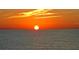 Beautiful sunset with orange hues reflects off the calm ocean water for a tranquil scene at 409 Bryn Mawr Is, Bradenton, FL 34207