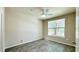 Comfortable bedroom with modern ceiling fan, plank flooring, and a large window at 4142 Central Sarasota Pkwy # 1423, Sarasota, FL 34238