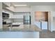Contemporary kitchen featuring stainless steel appliances, granite countertops, and a laundry closet at 4142 Central Sarasota Pkwy # 1423, Sarasota, FL 34238