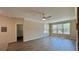 Bright living room featuring contemporary ceiling fan, crown molding, and luxury vinyl plank flooring at 4142 Central Sarasota Pkwy # 1423, Sarasota, FL 34238