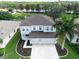 Aerial view of the home highlighting the lawn, landscaping, and large driveway at 4429 67Th E St, Bradenton, FL 34203