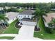 Beautiful home boasts a well-manicured lawn, a spacious driveway, and picturesque landscaping with mature palm trees at 4429 67Th E St, Bradenton, FL 34203