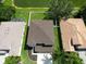Aerial view of a well-maintained property with lush green lawn and lake view at 4429 67Th E St, Bradenton, FL 34203