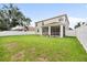Spacious backyard with a manicured lawn and a screened-in patio area, perfect for outdoor living at 4429 67Th E St, Bradenton, FL 34203