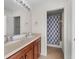 Bathroom features double sinks, framed mirrors, and a view of a shower with a patterned curtain at 4429 67Th E St, Bradenton, FL 34203