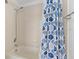 Bathroom with a shower and tub combination featuring blue patterned shower curtain and white tiles at 4429 67Th E St, Bradenton, FL 34203