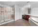 Bathroom featuring glass enclosed shower, soaking tub, and double vanity at 4429 67Th E St, Bradenton, FL 34203