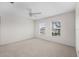 Spacious, carpeted bedroom with a ceiling fan and natural light from two windows at 4429 67Th E St, Bradenton, FL 34203