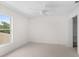 Bright, airy bedroom featuring a ceiling fan, neutral carpet, and natural light from a window at 4429 67Th E St, Bradenton, FL 34203