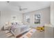 Stylishly furnished bedroom with a double bed, decorative rug, and two bright, sunlit windows at 4429 67Th E St, Bradenton, FL 34203